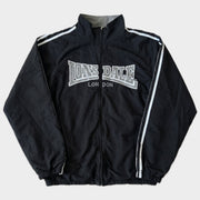 Glattes Liegefoto: Vintage Lonsdale Trackjacket (M) (KI-Aufbereitung, Zustand siehe echte Fotos)
